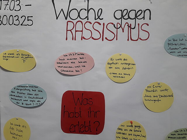Auf einem Plakat steht die Frage: Hast du Rassismus erlebt?
